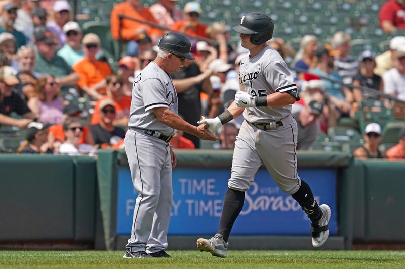 Aug 30, 2023; Baltimore, Maryland, USA; Chicago White Sox first baseman Andrew Vaughn (25) greeted by coach Eddie Rodriguez (18) following his two run home run in the second inning against the Baltimore Orioles at Oriole Park at Camden Yards. Mandatory Credit: Mitch Stringer-USA TODAY Sports