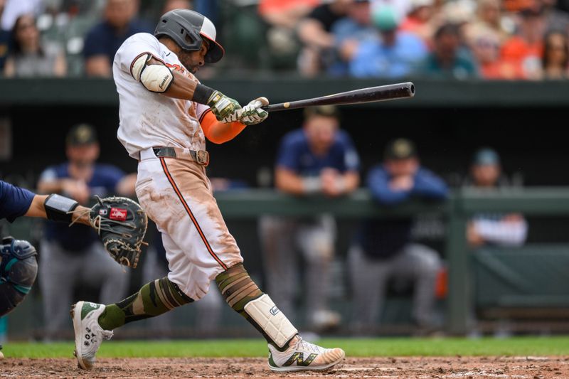 May 19, 2024; Baltimore, Maryland, USA; Baltimore Orioles outfielder Cedric Mullins (31) hits a single during the eighth inning against the Seattle Mariners at Oriole Park at Camden Yards. Mandatory Credit: Reggie Hildred-USA TODAY Sports