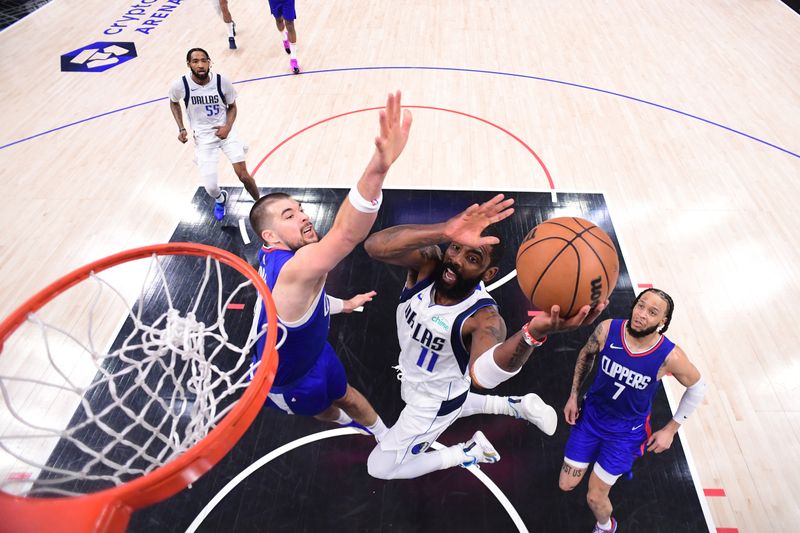 LOS ANGELES, CA - APRIL 21:  Kyrie Irving #11 of the Dallas Mavericks drives to the basket during the game against the LA Clippers during Round 1 Game 1 of the 2024 NBA Playoffs on April 21, 2024 at Crypto.Com Arena in Los Angeles, California. NOTE TO USER: User expressly acknowledges and agrees that, by downloading and/or using this Photograph, user is consenting to the terms and conditions of the Getty Images License Agreement. Mandatory Copyright Notice: Copyright 2024 NBAE (Photo by Adam Pantozzi/NBAE via Getty Images)