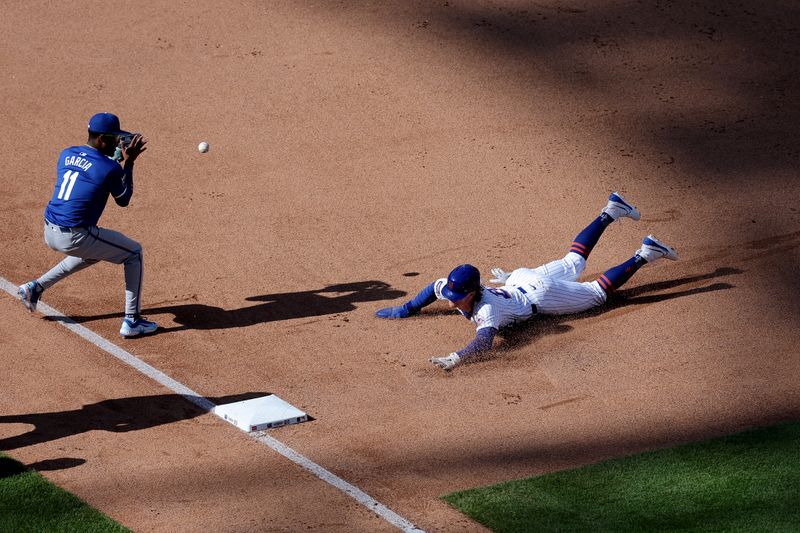 Apr 14, 2024; New York City, New York, USA; New York Mets pinch hitter Brett Baty (22) slides safely into third base against Kansas City Royals third baseman Maikel Garcia (11) on a double by Mets left fielder Brandon Nimmo (not pictured) during the seventh inning at Citi Field. Mandatory Credit: Brad Penner-USA TODAY Sports