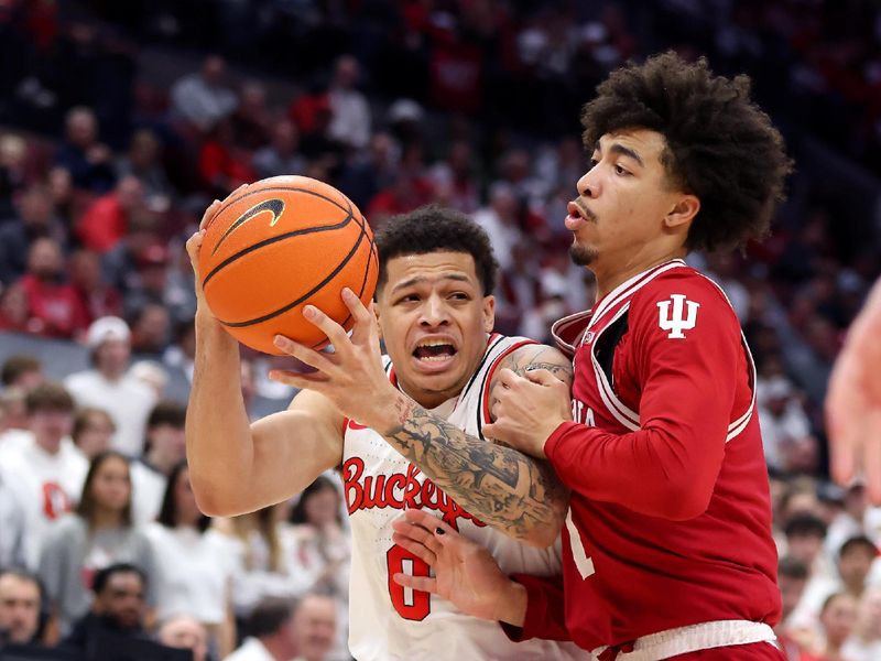 Jan 17, 2025; Columbus, Ohio, USA; Ohio State Buckeyes guard John Mobley Jr. (0) drives to the basket as Indiana Hoosiers guard Kanaan Carlyle (9) defends during the second half at Value City Arena. Mandatory Credit: Joseph Maiorana-Imagn Images