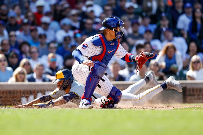 May 3, 2024; Chicago, Illinois, USA; Milwaukee Brewers outfielder Jackson Chourio (11) scores as Chicago Cubs catcher Miguel Amaya (9) waits for the ball during the eight inning at Wrigley Field. Mandatory Credit: Kamil Krzaczynski-USA TODAY Sports