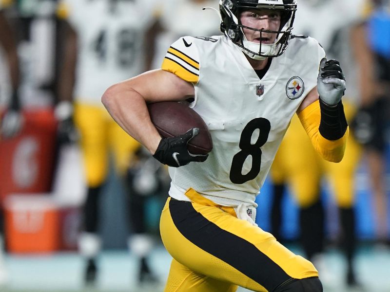 Pittsburgh Steelers quarterback Kenny Pickett (8) aims a pass during the first half of an NFL football game against the Miami Dolphins, Sunday, Oct. 23, 2022, in Miami Gardens, Fla. (AP Photo/Wilfredo Lee )