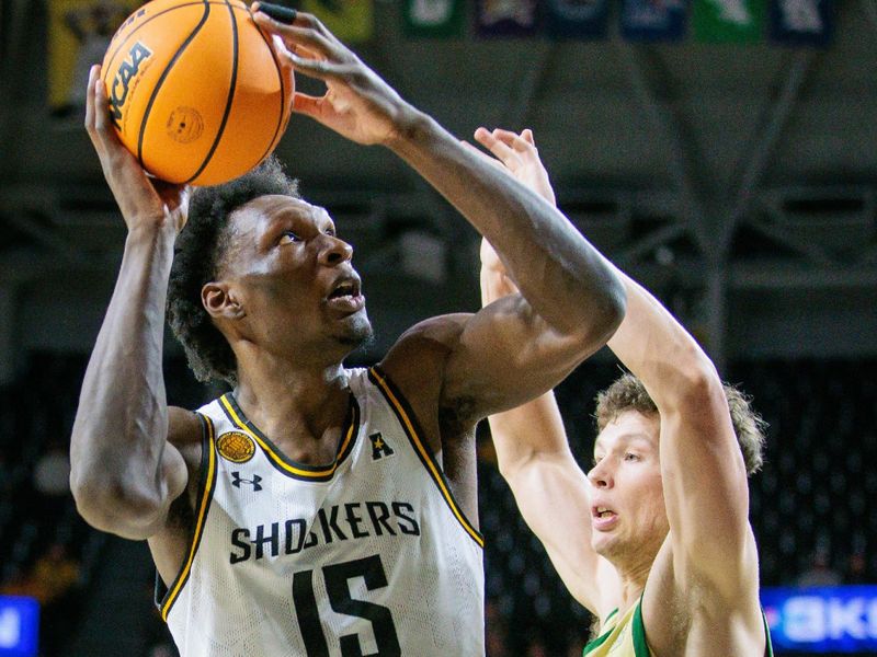 Jan 14, 2025; Wichita, Kansas, USA; Wichita State Shockers center Quincy Ballard (15) shoots the ball around Charlotte 49ers forward Rich Rolf (24) during the second half at Charles Koch Arena. Mandatory Credit: William Purnell-Imagn Images