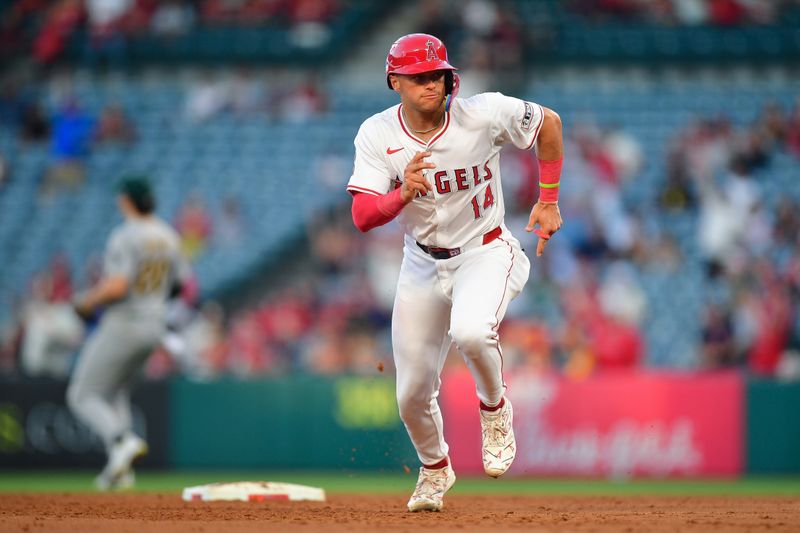 Jun 25, 2024; Anaheim, California, USA; Los Angeles Angels catcher Logan O'Hoppe (14) runs to third against the Oakland Athletics during the fourth inning at Angel Stadium. Mandatory Credit: Gary A. Vasquez-USA TODAY Sports