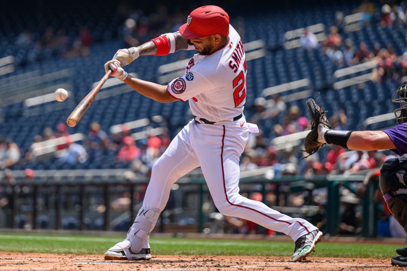 Jul 26, 2023; Washington, District of Columbia, USA; Washington Nationals first baseman Dominic Smith (22) hits a pitch during the fourth inning against the Colorado Rockies at Nationals Park. Mandatory Credit: Reggie Hildred-USA TODAY Sports