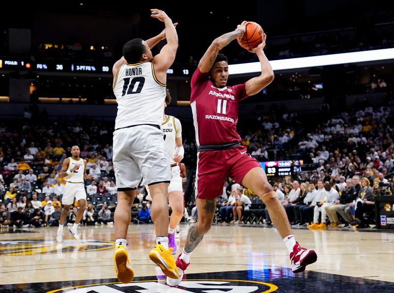 Jan 31, 2024; Columbia, Missouri, USA; Arkansas Razorbacks forward Jalen Graham (11) drives against Missouri Tigers guard Nick Honor (10) during the second half at Mizzou Arena. Mandatory Credit: Jay Biggerstaff-USA TODAY Sports