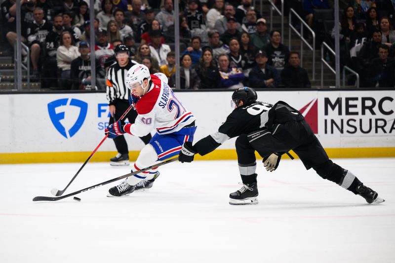 Mar 7, 2026; Los Angeles, California, USA; Montréal Canadiens left wing Juraj Slafkovský (20) controls the puck while under pressure from Los Angeles Kings defenseman Brandt Clarke (92) during the third period at Crypto.com Arena. Mandatory Credit: William Liang-Imagn Images