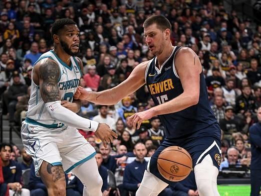 DENVER, CO - JANUARY 1: Nikola Jokic (15) of the Denver Nuggets guards Miles Bridges (0) of the Charlotte Hornets during the second quarter at Ball Arena in Denver on Monday, January 1, 2024. (Photo by AAron Ontiveroz/The Denver Post)