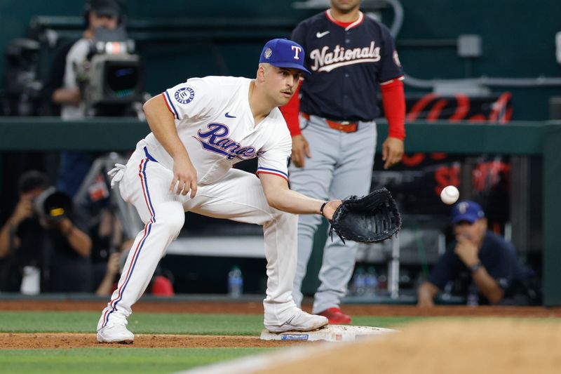 May 1, 2024; Arlington, Texas, USA; Texas Rangers first base Nathaniel Lowe (30) fields a ball during the ninth inning against the Washington Nationals at Globe Life Field. Mandatory Credit: Andrew Dieb-USA TODAY Sports