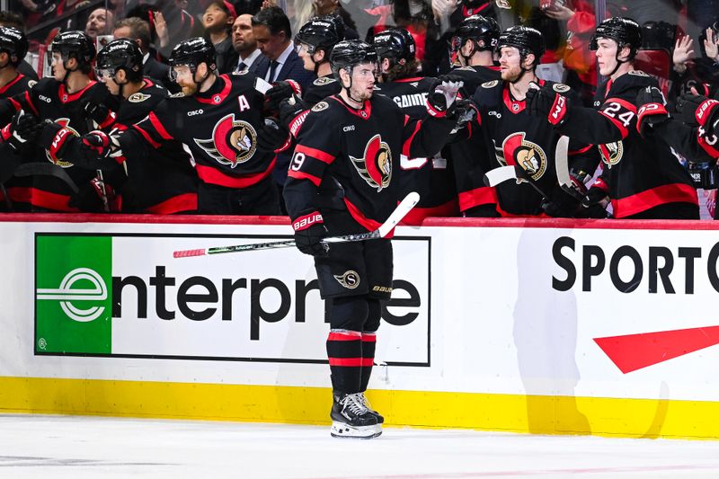 Nov 25, 2024; Ottawa, Ontario, CAN; Ottawa Senators right wing Drake Batherson (19) celebrates his goal against the Calgary Flames with his teammates at the bench during the second period at Canadian Tire Centre. Mandatory Credit: David Kirouac-Imagn Images