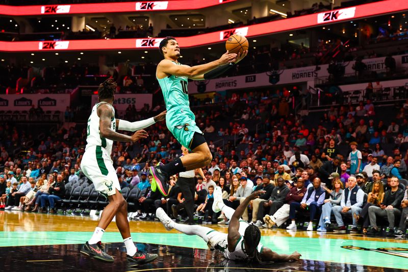 CHARLOTTE, NORTH CAROLINA - NOVEMBER 16: Josh Green #10 of the Charlotte Hornets lays the ball up during the first half of a basketball game against the Milwaukee Bucks at Spectrum Center on November 16, 2024 in Charlotte, North Carolina. NOTE TO USER: User expressly acknowledges and agrees that, by downloading and or using this photograph, User is consenting to the terms and conditions of the Getty Images License Agreement. (Photo by David Jensen/Getty Images)