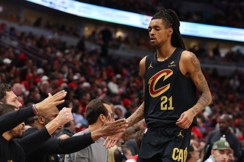 CHICAGO, ILLINOIS - DECEMBER 23: Emoni Bates #21 of the Cleveland Cavaliers high fives teammates against the Chicago Bulls during the first half at the United Center on December 23, 2023 in Chicago, Illinois. NOTE TO USER: User expressly acknowledges and agrees that, by downloading and or using this photograph, User is consenting to the terms and conditions of the Getty Images License Agreement.  (Photo by Michael Reaves/Getty Images)