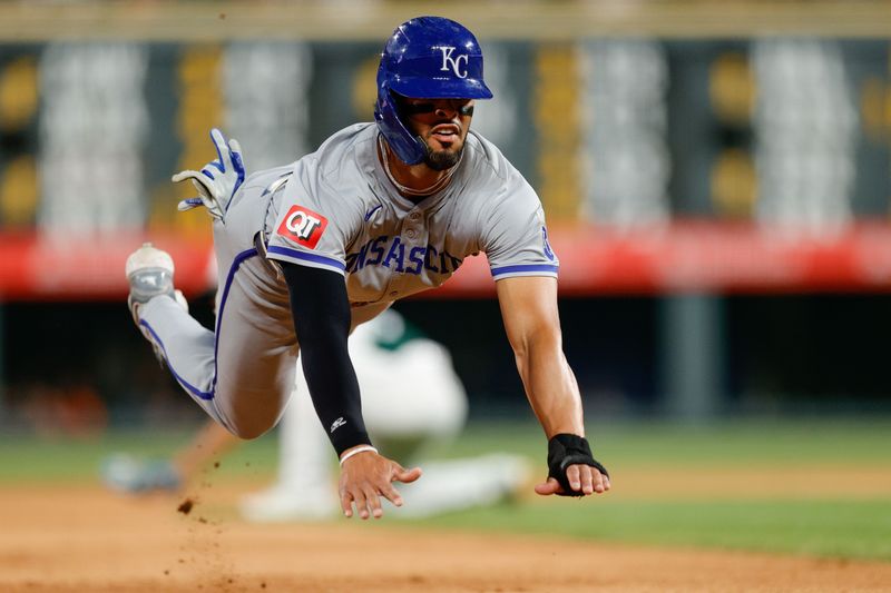 Jul 6, 2024; Denver, Colorado, USA; Kansas City Royals left fielder MJ Melendez (1) slides into third in the seventh inning against the Colorado Rockies at Coors Field. Mandatory Credit: Isaiah J. Downing-USA TODAY Sports