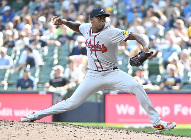 Jul 31, 2024; Milwaukee, Wisconsin, USA; Atlanta Braves pitcher Raisel Iglesias (26) delivers against the Milwaukee Brewers in the ninth inning at American Family Field. Mandatory Credit: Michael McLoone-USA TODAY Sports