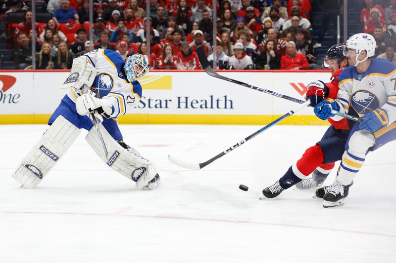 Nov 22, 2023; Washington, District of Columbia, USA; Buffalo Sabres goaltender Devon Levi (27) clears the puck from Washington Capitals right wing Nicolas Aube-Kubel (96) and Sabres defenseman Connor Clifton (75) in the first period at Capital One Arena. Mandatory Credit: Geoff Burke-USA TODAY Sports