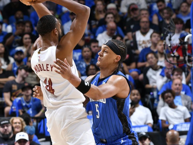 ORLANDO, FL - APRIL 27: Evan Mobley #4 of the Cleveland Cavaliers looks to pass the ball during the game against the Orlando Magic during Round 1 Game 4 of the 2024 NBA Playoffs on April 27, 2024 at the Kia Center in Orlando, Florida. NOTE TO USER: User expressly acknowledges and agrees that, by downloading and or using this photograph, User is consenting to the terms and conditions of the Getty Images License Agreement. Mandatory Copyright Notice: Copyright 2024 NBAE (Photo by Fernando Medina/NBAE via Getty Images)