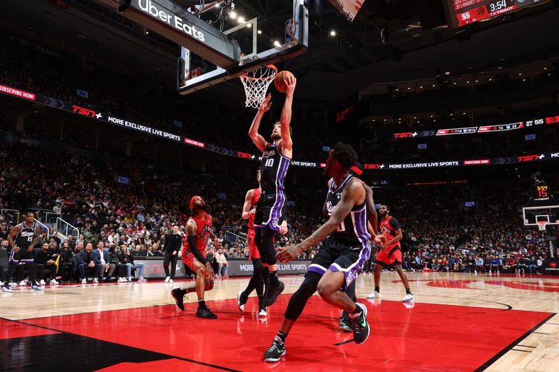 TORONTO, CANADA - MARCH 20: Domantas Sabonis #10 of the Sacramento Kings drives to the basket during the game against the Toronto Raptors on March 20, 2024 at the Scotiabank Arena in Toronto, Ontario, Canada.  NOTE TO USER: User expressly acknowledges and agrees that, by downloading and or using this Photograph, user is consenting to the terms and conditions of the Getty Images License Agreement.  Mandatory Copyright Notice: Copyright 2024 NBAE (Photo by Vaughn Ridley/NBAE via Getty Images)