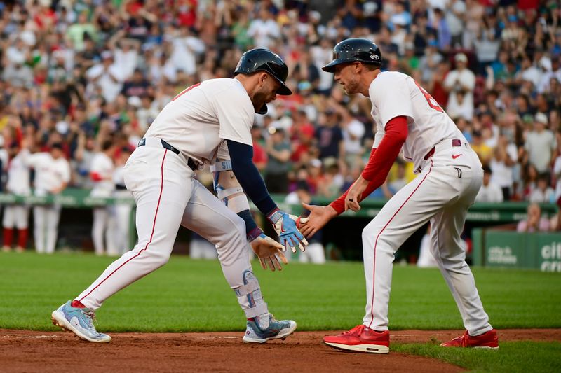 Jun 30, 2025; Boston, Massachusetts, USA; Boston Red Sox shortstop Trevor Story (10) is greeted by third base coach/outfield instructor Kyle Hudson (84) after hitting a three-run home run during the first inning against the Cincinnati Reds at Fenway Park. Mandatory Credit: Bob DeChiara-Imagn Images