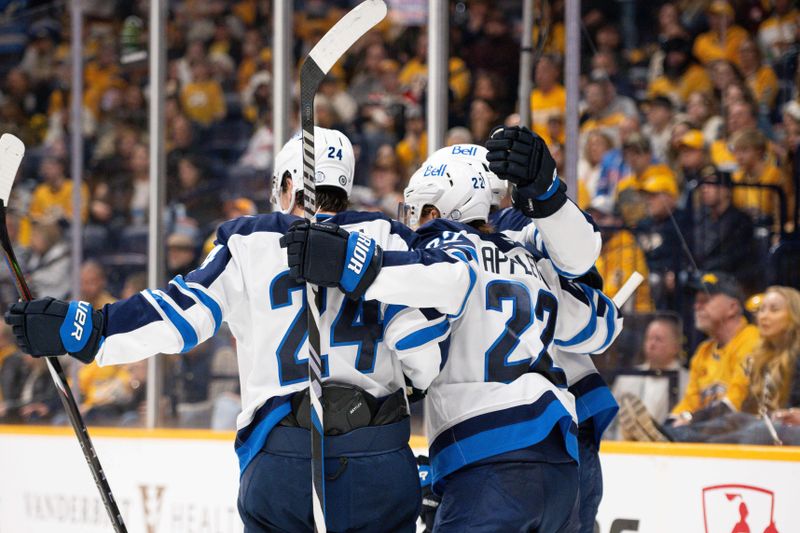 Nov 23, 2024; Nashville, Tennessee, USA;  Winnipeg Jets center Adam Lowry (17) celebrates his goal with his teammates against the Nashville Predators during the second period at Bridgestone Arena. Mandatory Credit: Steve Roberts-Imagn Images