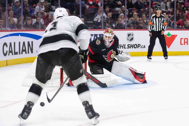 Oct 14, 2024; Ottawa, Ontario, CAN;  Ottawa Senators goalie Mads Sogaard (40) follows Los Angeles Kings center Anze Kopitar (11) who controls the puck in the second period at the Canadian Tire Centre. Mandatory Credit: Marc DesRosiers-Imagn Images