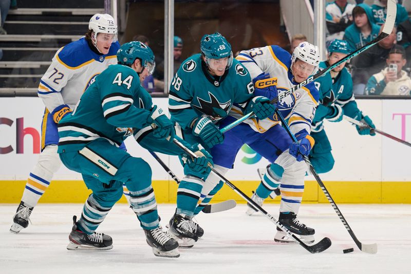 Jan 27, 2024; San Jose, California, USA; Buffalo Sabres left wing Jeff Skinner (53) defends the puck against San Jose Sharks center Mike Hoffman (68) and defenseman Marc-Edouard Vlasic (44) during the third period at SAP Center at San Jose. Mandatory Credit: Robert Edwards-USA TODAY Sports