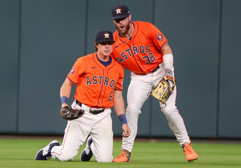 Jun 21, 2024; Houston, Texas, USA; Houston Astros right fielder Trey Cabbage (38) celebrates center fielder Jake Meyers (6) catch against the Baltimore Orioles to end the top of the third inning against the Baltimore Orioles at Minute Maid Park. Mandatory Credit: Thomas Shea-USA TODAY Sports