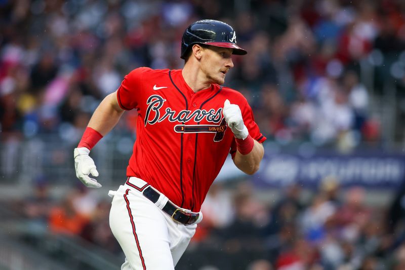 May 5, 2023; Atlanta, Georgia, USA; Atlanta Braves catcher Sean Murphy (12) hits a RBI single against the Baltimore Orioles in the first inning at Truist Park. Mandatory Credit: Brett Davis-USA TODAY Sports