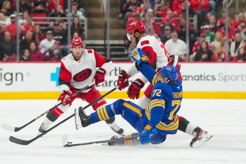 Nov 8, 2025; Raleigh, North Carolina, USA;  Carolina Hurricanes defenseman K'Andre Miller (19) checks Buffalo Sabres center Tage Thompson (72) during the third period at Lenovo Center. Mandatory Credit: James Guillory-Imagn Images