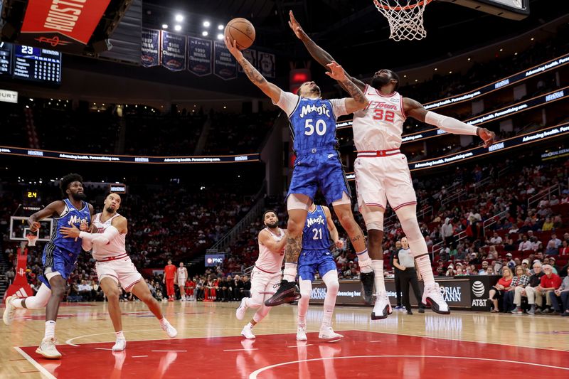 HOUSTON, TEXAS - APRIL 09: Cole Anthony #50 of the Orlando Magic goes up for a shot while defended by Jeff Green #32 of the Houston Rockets in the first half at Toyota Center on April 09, 2024 in Houston, Texas.  NOTE TO USER: User expressly acknowledges and agrees that, by downloading and or using this photograph, User is consenting to the terms and conditions of the Getty Images License Agreement. (Photo by Tim Warner/Getty Images)