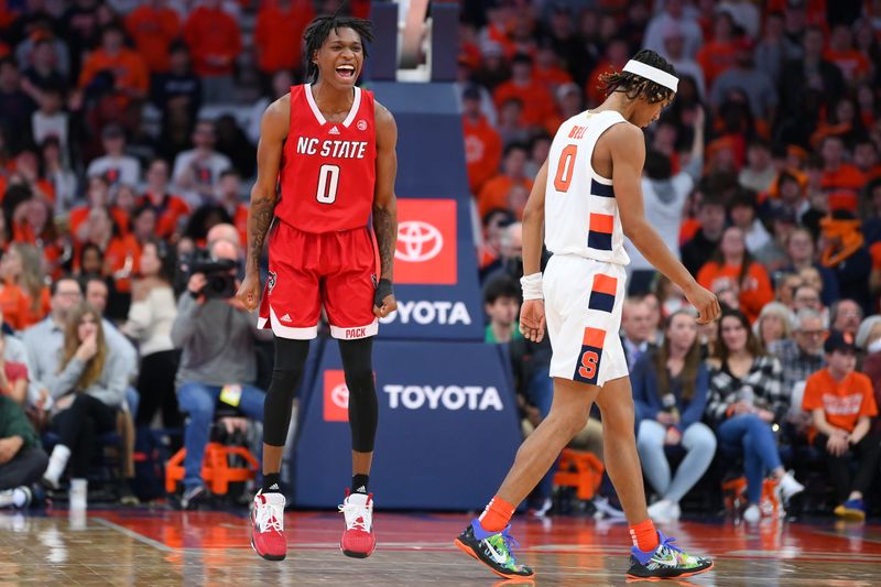 Feb 14, 2023; Syracuse, New York, USA; North Carolina State Wolfpack guard Terquavion Smith (0) reacts to a play as Syracuse Orange forward Chris Bell (0) walks off the court during the second half at the JMA Wireless Dome. Mandatory Credit: Rich Barnes-USA TODAY Sports