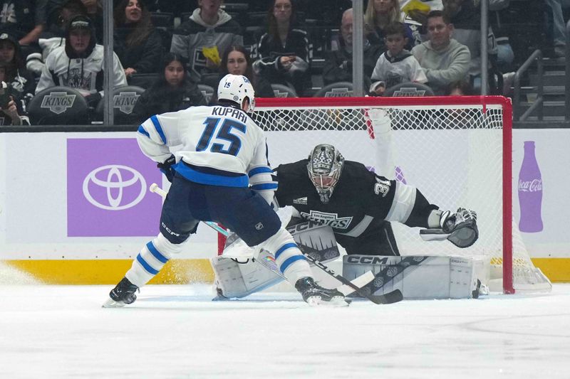 Nov 27, 2024; Los Angeles, California, USA; LA Kings goaltender David Rittich (31) defends against Winnipeg Jets center Rasmus Kupari (15) on a penalty shot in the second period at Crypto.com Arena. Mandatory Credit: Kirby Lee-Imagn Images