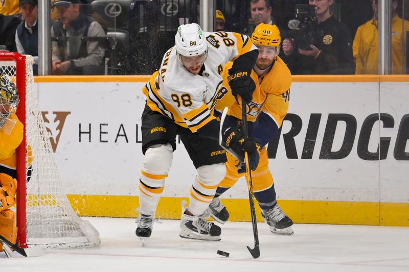 Mar 5, 2026; Nashville, Tennessee, USA;  Boston Bruins right wing David Pastrnak (88) and Nashville Predators defenseman Nick Perbix (48) battle for the puck during the second period at Bridgestone Arena. Mandatory Credit: Steve Roberts-Imagn Images