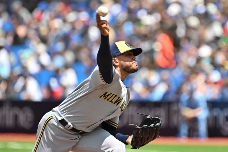 Jun 1, 2023; Toronto, Ontario, CAN;  Milwaukee Brewers starting pitcher Freddy Peralta (51) delivers a pitch against the Toronto Blue Jays in the first inning at Rogers Centre. Mandatory Credit: Dan Hamilton-USA TODAY Sports