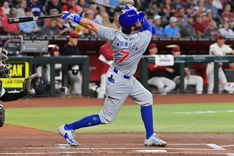 Apr 17, 2024; Phoenix, Arizona, USA;  Chicago Cubs shortstop Dansby Swanson (7) singles in the first inning against the Arizona Diamondbacks at Chase Field. Mandatory Credit: Matt Kartozian-USA TODAY Sports