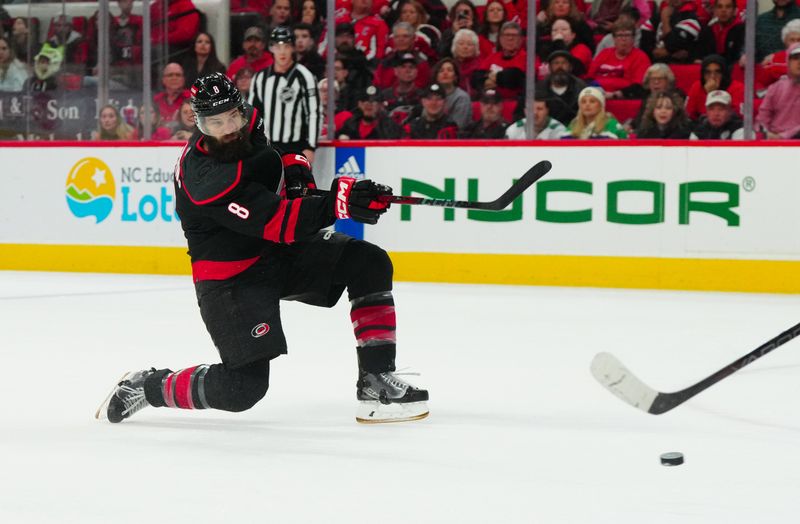 Apr 5, 2024; Raleigh, North Carolina, USA; Carolina Hurricanes defenseman Brent Burns (8) takes a shot against the Washington Capitals during the first period at PNC Arena. Mandatory Credit: James Guillory-USA TODAY Sports