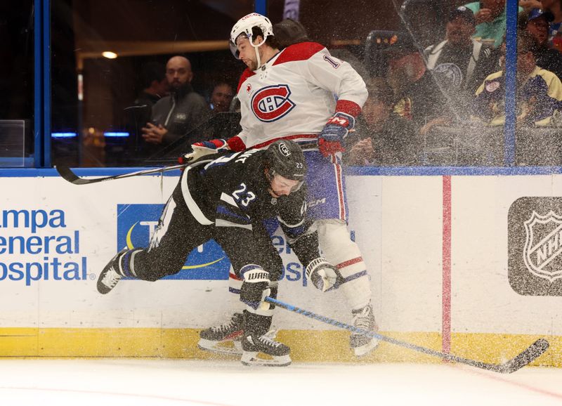 Mar 2, 2024; Tampa, Florida, USA;  dTampa Bay Lightning center Michael Eyssimont (23) checks Montreal Canadiens right wing Josh Anderson (17) during the second period at Amalie Arena. Mandatory Credit: Kim Klement Neitzel-USA TODAY Sports