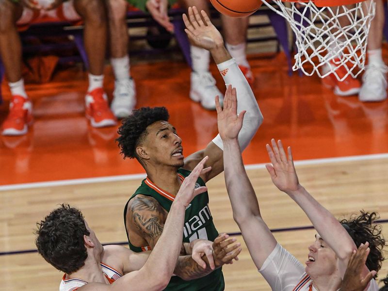 Feb 4, 2023; Clemson, South Carolina, USA; Miami guard Bensley Joseph (4) shoots near Clemson sophomore forward PJ Hall (24) during the first half at Littlejohn Coliseum in Clemson, S.C. Saturday, Feb. 4, 2023.  Mandatory Credit: Ken Ruinard-USA TODAY Sports