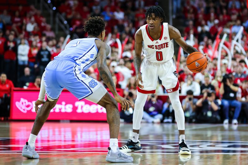 Feb 19, 2023; Raleigh, North Carolina, USA;  North Carolina State Wolfpack guard Terquavion Smith (0) dribbles against North Carolina Tar Heels forward Leaky Black (1) during the first half of the game at PNC Arena. Mandatory Credit: Jaylynn Nash-USA TODAY Sports