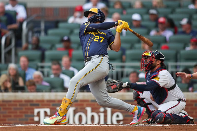 Aug 6, 2024; Atlanta, Georgia, USA; Milwaukee Brewers shortstop Willy Adames (27) hits a two-run home run against the Atlanta Braves in the first inning at Truist Park. Mandatory Credit: Brett Davis-USA TODAY Sports