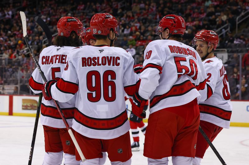 Nov 21, 2024; Newark, New Jersey, USA; Carolina Hurricanes center Jack Roslovic (96) celebrates his goal against the New Jersey Devils during the first period at Prudential Center. Mandatory Credit: Ed Mulholland-Imagn Images