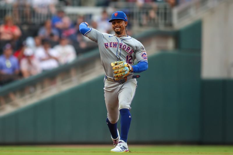 Sep 30, 2024; Atlanta, Georgia, USA; New York Mets shortstop Francisco Lindor (12) throws a runner out at first against the Atlanta Braves in the sixth inning at Truist Park. Mandatory Credit: Brett Davis-Imagn Images