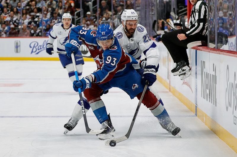 Nov 4, 2025; Denver, Colorado, USA; Colorado Avalanche center Zakhar Bardakov (93) and Tampa Bay Lightning center Zemgus Girgensons (28) battle for the puck in the first period at Ball Arena. Mandatory Credit: Isaiah J. Downing-Imagn Images