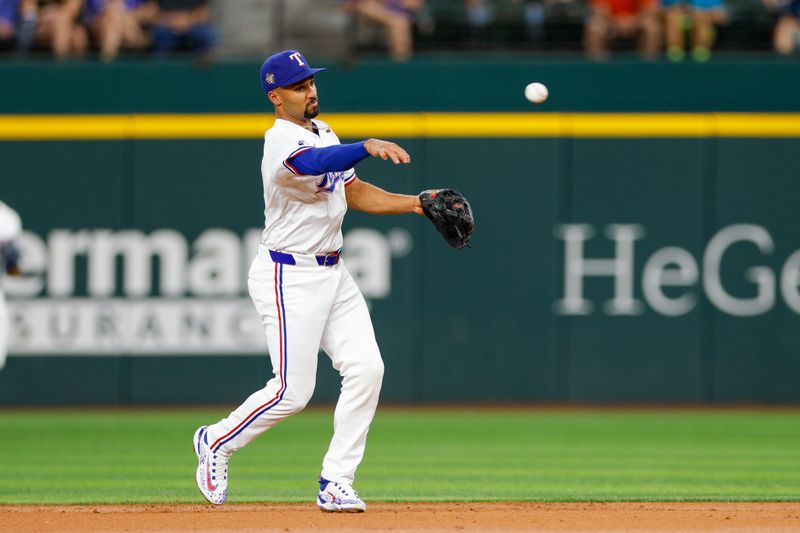 May 15, 2024; Arlington, Texas, USA; Texas Rangers second base Marcus Semien (2) fields a ground ball during the second inning against the Cleveland Guardians at Globe Life Field. Mandatory Credit: Andrew Dieb-USA TODAY Sports