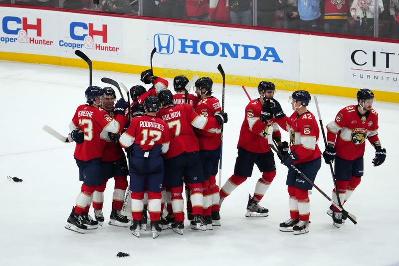 Jan 11, 2024; Sunrise, Florida, USA; Florida Panthers teammates celebrate after defeating the Los Angeles Kings in overtime at Amerant Bank Arena. Mandatory Credit: Jasen Vinlove-USA TODAY Sports