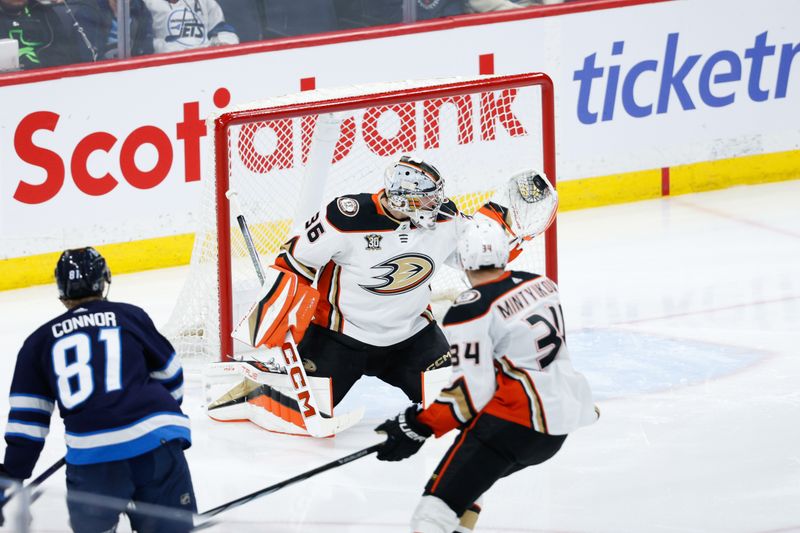 Mar 15, 2024; Winnipeg, Manitoba, CAN; Anaheim Ducks goalie John Gibson (36) makes a save on a shot by Winnipeg Jets forward Kyle Connor (81) during the third period at Canada Life Centre. Mandatory Credit: Terrence Lee-USA TODAY Sports