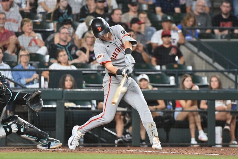 Jun 30, 2025; Phoenix, Arizona, USA;  San Francisco Giants second baseman Tyler Fitzgerald (49) hits a two RBI double in the seventh inning against the Arizona Diamondbacks at Chase Field. Mandatory Credit: Matt Kartozian-Imagn Images