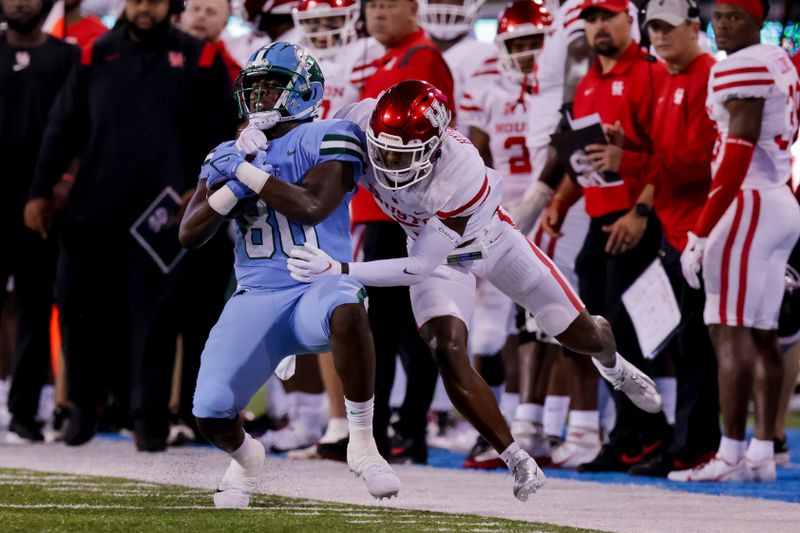 Oct 7, 2021; New Orleans, Louisiana, USA;  Tulane Green Wave tight end Tyrick James (80) catches a pass for 34 yards against Houston Cougars safety Hasaan Hypolite (5)  during the first half at Yulman Stadium. Mandatory Credit: Stephen Lew-USA TODAY Sports