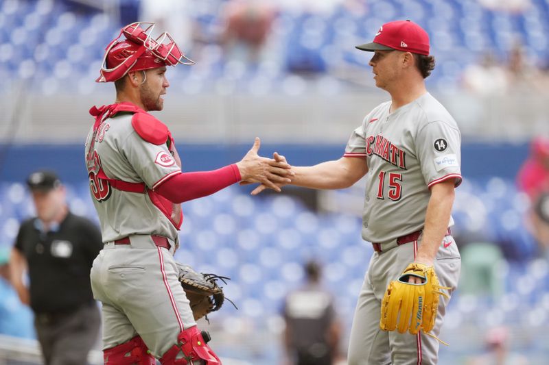 Apr 23, 2025; Miami, Florida, USA;  Cincinnati Reds pitcher Emilio Pag·n (15) congratulates catcher Austin Wynns (38) after a victory against the Miami Marlins at loanDepot Park. Mandatory Credit: Jim Rassol-Imagn Images