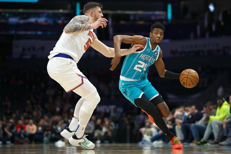 CHARLOTTE, NORTH CAROLINA - JANUARY 29: Brandon Miller #24 of the Charlotte Hornets drives to the basket against Isaiah Hartenstein #55 of the New York Knicks during the first half of the game at Spectrum Center on January 29, 2024 in Charlotte, North Carolina. NOTE TO USER: User expressly acknowledges and agrees that, by downloading and or using this photograph, User is consenting to the terms and conditions of the Getty Images License Agreement. (Photo by Jared C. Tilton/Getty Images)